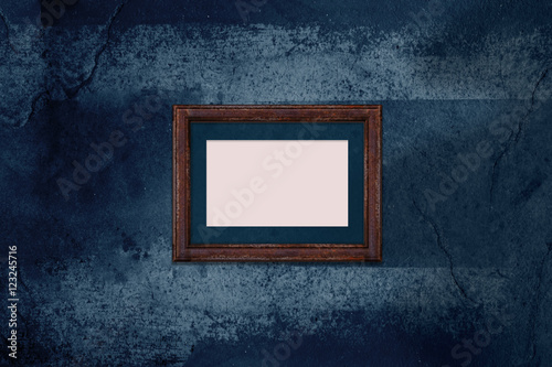 Grunge concrete wall with blank rusty photo frame in the darkness scene, Template mock up for display photo or product