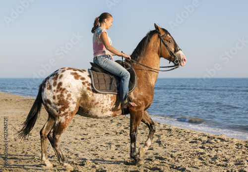 woman and appaloosa horse