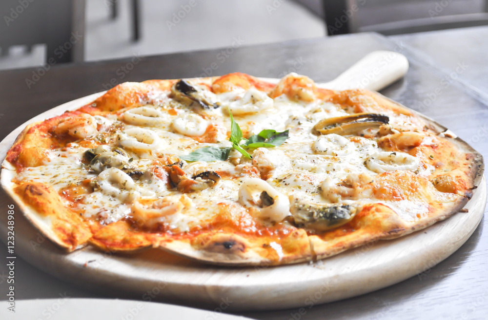 seafood pizza in wooden tray or thin pizza seafood pizza in wooden tray or thin pizza
