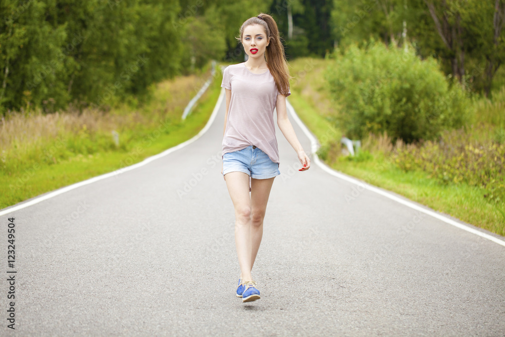 Portrait of young brunette woman in blue jeans short Portrait of young brunette woman in blue jeans short