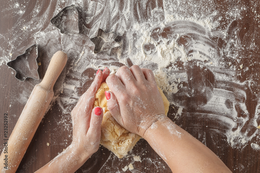 Fototapeta premium Woman make ginger bread for Christmas. Natural Colors. Real life