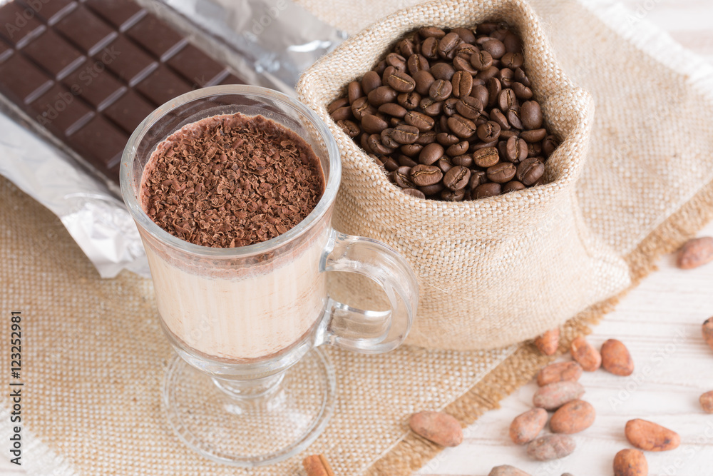 Fresh Made Chocolate Banana Smoothie on a wooden table with coffee and spices. Milkshake. Protein diet. Healthy food concept. Drink, cocoa beans, chocolate. Fresh Made Chocolate Banana Smoothie on a wooden table with coffee and spices. Milkshake. Protein diet. Healthy food concept. Drink, cocoa beans, chocolate.
