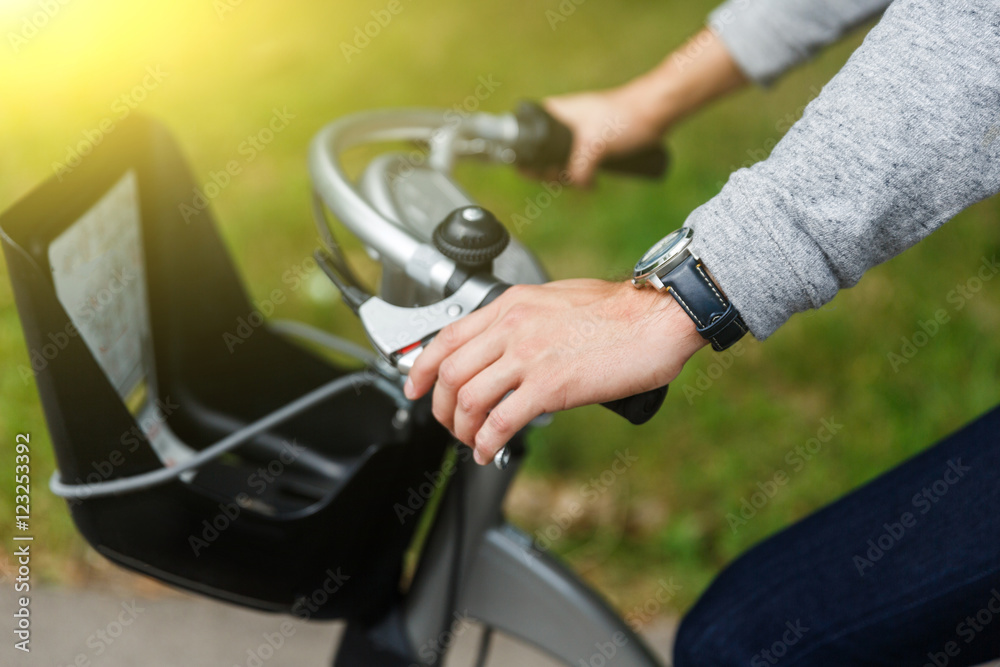 Man sitting on bicycle and holding wheel Man sitting on bicycle and holding wheel