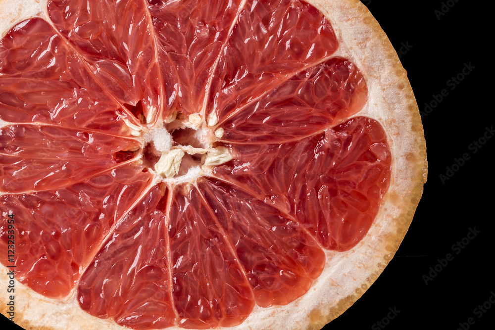 Background of ripe grapefruit Slice on black Background of ripe grapefruit Slice on black