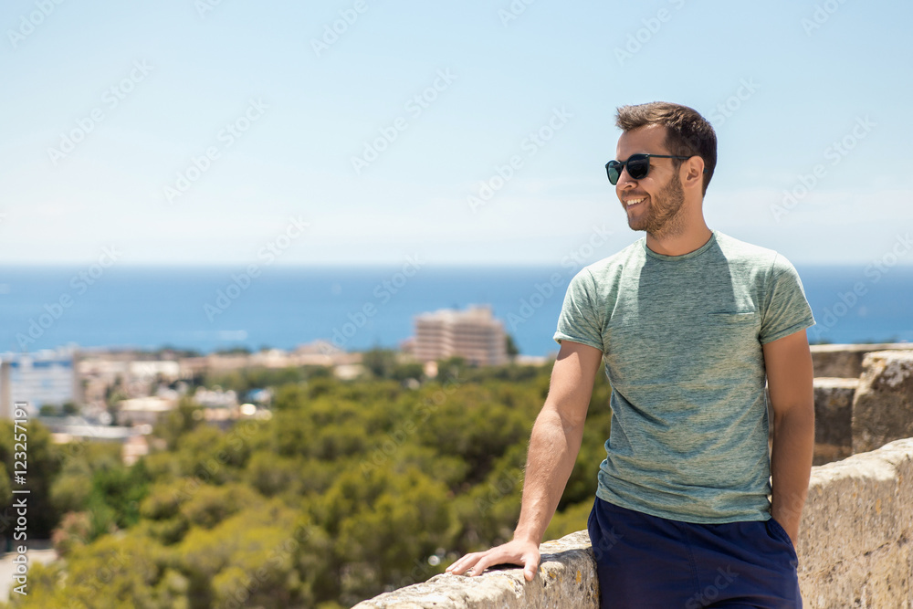 Handsome man posing in sea scenery