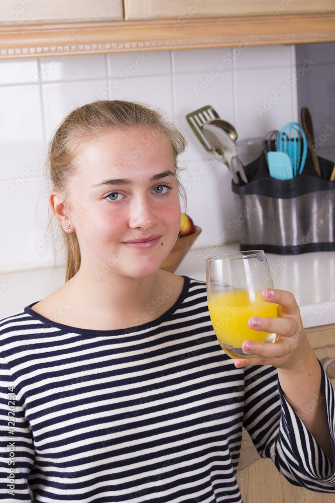 Girl with glass of juice in kitchen Girl with glass of juice in kitchen