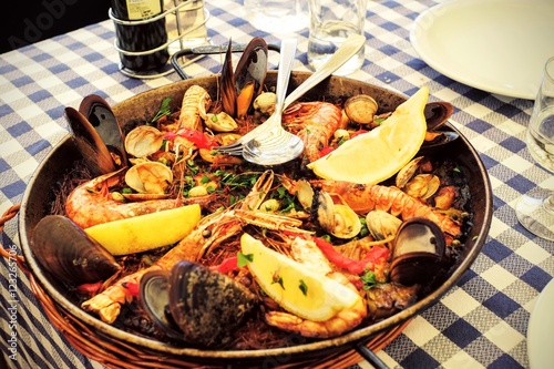 Photography Traditional Home made Spanish Fideua, a noodle Paella with seafo