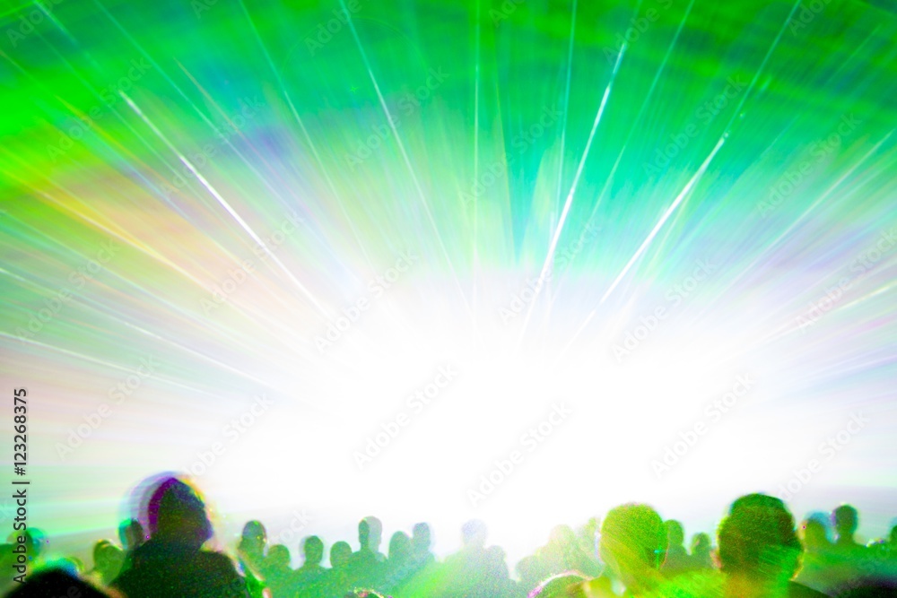 Bright laser show rays stream. Very colorful show with a crowd silhouette and great laser rays on pyrotechnic party