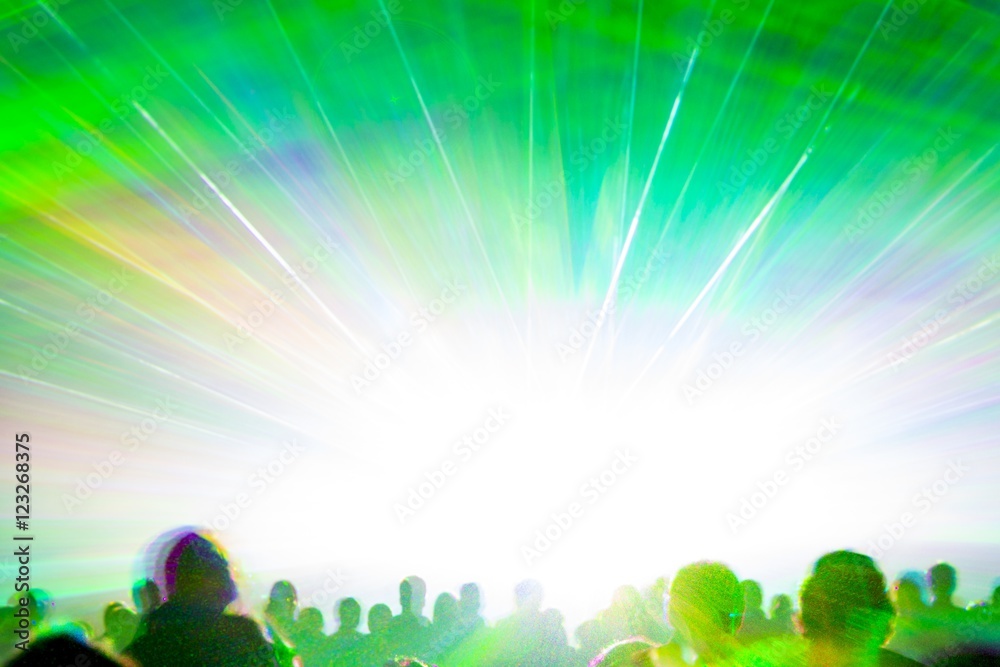 Bright laser show rays stream. Very colorful show with a crowd silhouette and great laser rays on pyrotechnic party Bright laser show rays stream. Very colorful show with a crowd silhouette and great laser rays on pyrotechnic party