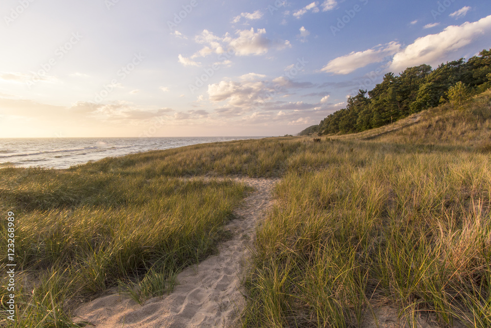 Summer Vacation At The Beach.  Winding path through dune grass and sand dunes on the shores of Lake Michigan. Hoffmaster State Park, Michigan