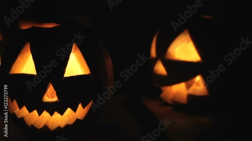 Glowing scary pumpkin at night on the steps