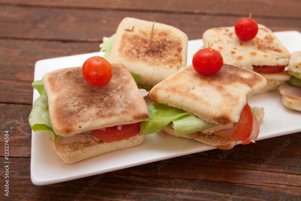 Small sandwiches with salmon, cheese and vegetables Small sandwiches with salmon, cheese and vegetables