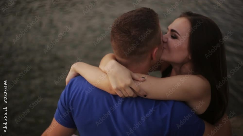 Romantic date. Couple in love on the shore near the water Romantic date. Couple in love on the shore near the water