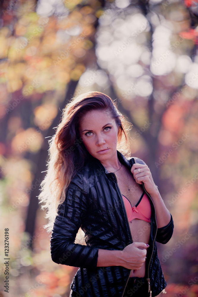 Girl in autumn leaves in a leather jacket Girl in autumn leaves in a leather jacket