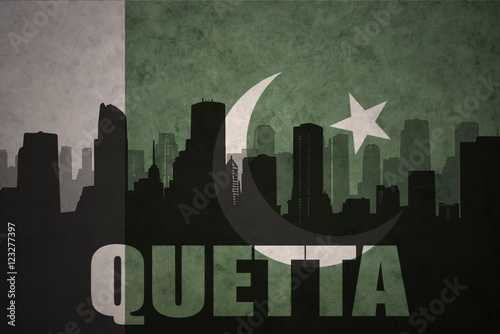 abstract silhouette of the city with text Quetta at the vintage pakistan flag background photo