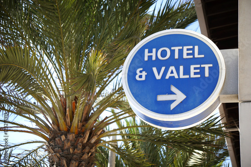 hotel and valet sign with palm trees