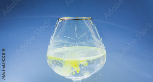 Wine glass filled with red and yellow ink
