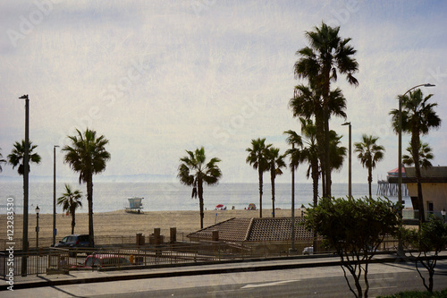aged and worn vintage photo of Huntington Beach California with palm trees