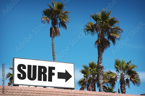 surf sign on building with palm trees © jdoms