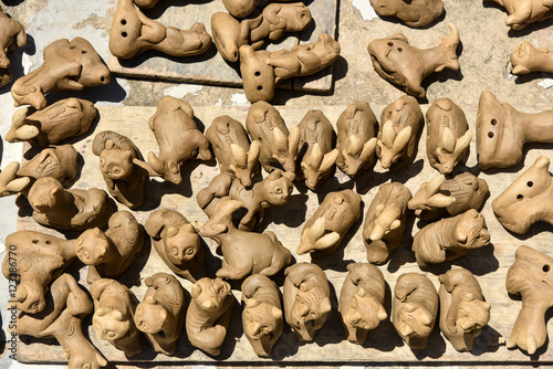 Top view of different animal whistles in sunlight. Pottery village in Vietnam. photo