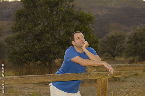 Man leaning on a fence dreaming of tomorrow. © artsyobjects