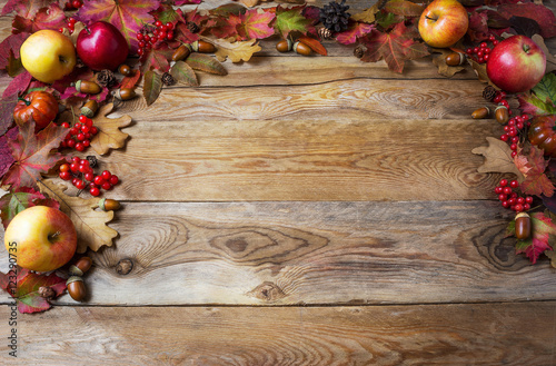 Thanksgiving concept with apples, acorns, berries and fall leave