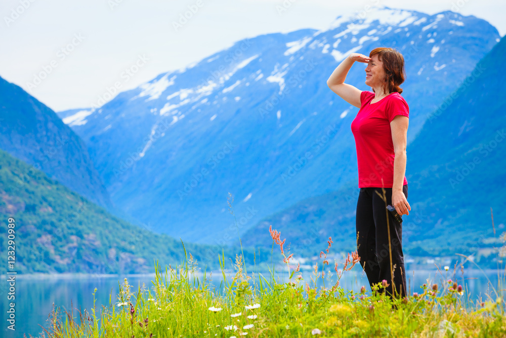 Tourist woman enjoying fjord view in Norway Tourist woman enjoying fjord view in Norway