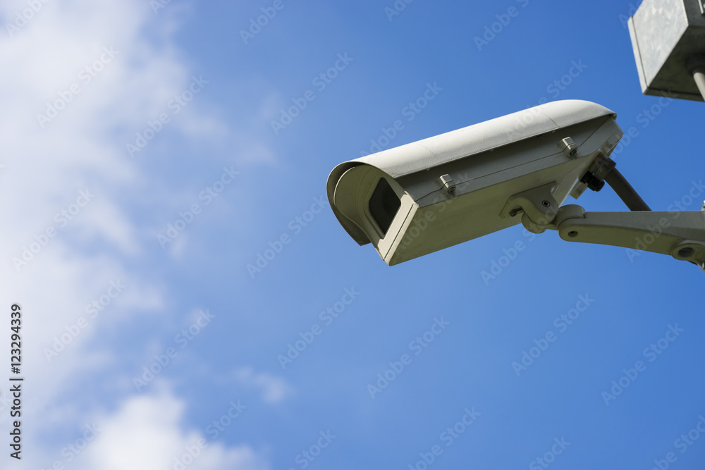 Security camera on blue sky background