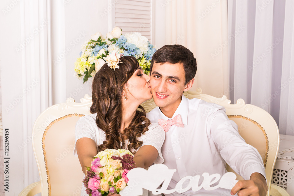 couple holding a sign with the word love