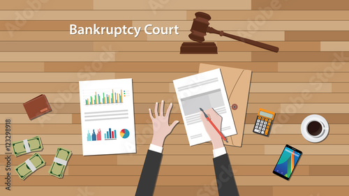 bankcruptcy court concept with business man work on paper document  chart and graph  top of wooden table