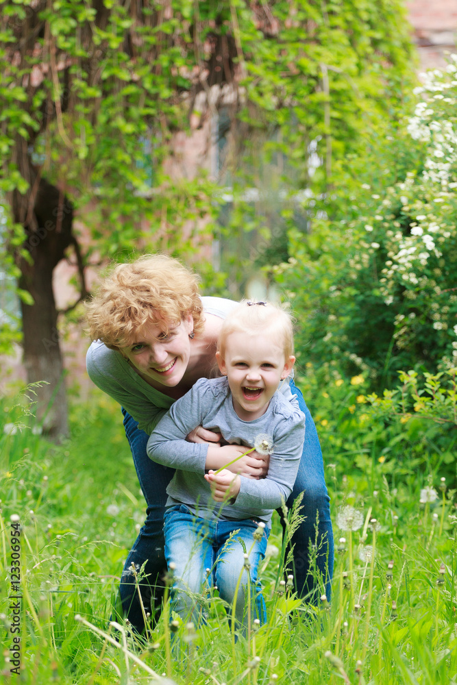 Fototapeta premium Mother and daughter in spring sunny park