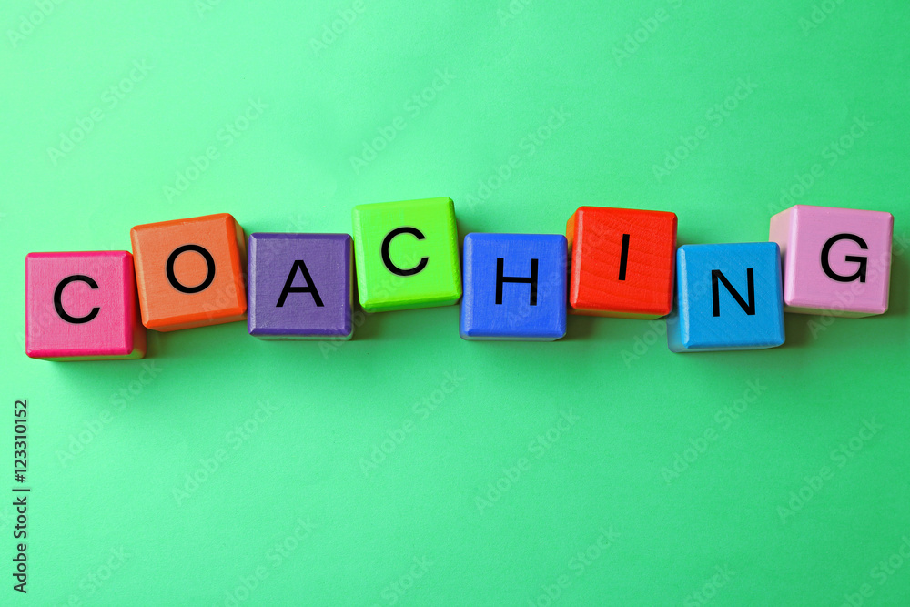 Coaching concept. Wooden cubes on green background Coaching concept. Wooden cubes on green background