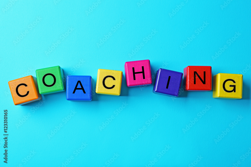 Coaching concept. Wooden cubes on blue background Coaching concept. Wooden cubes on blue background
