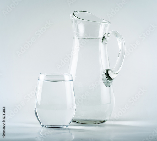 Jug and glass on white background
