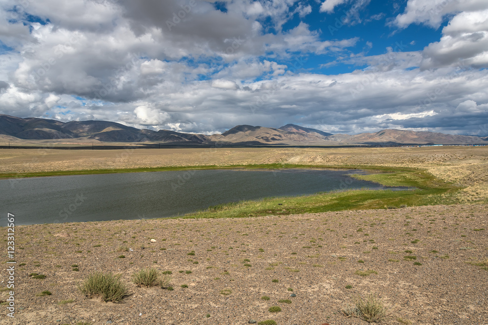 lake steppe sky clouds mountains