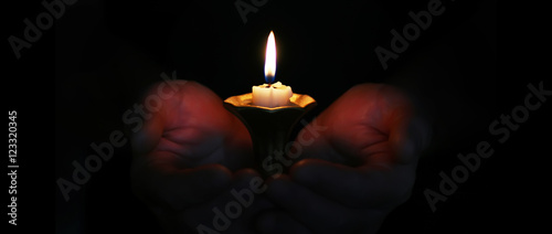 burning candle in a hand