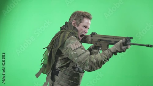 Solider shooting rifle on green screen