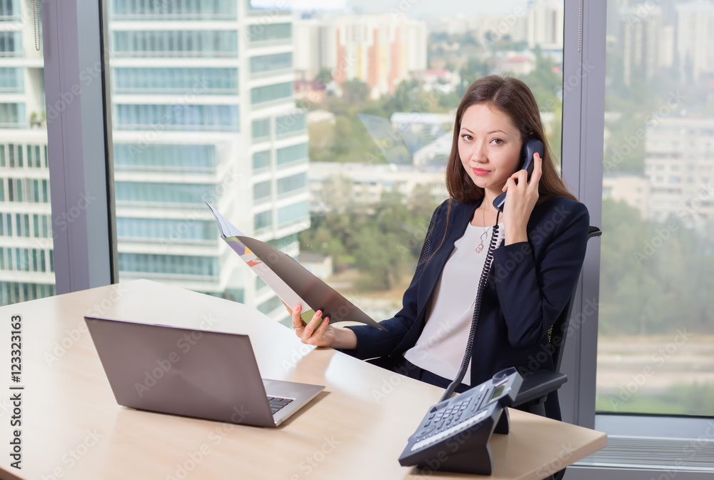 Young asian business woman in suit working on laptop Young asian business woman in suit working on laptop