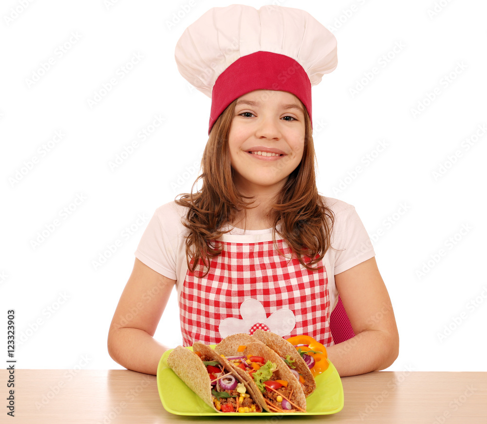 Happy little girl cook with tacos on table Happy little girl cook with tacos on table