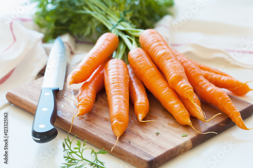 raw carrot vegetable on wooden chopping board