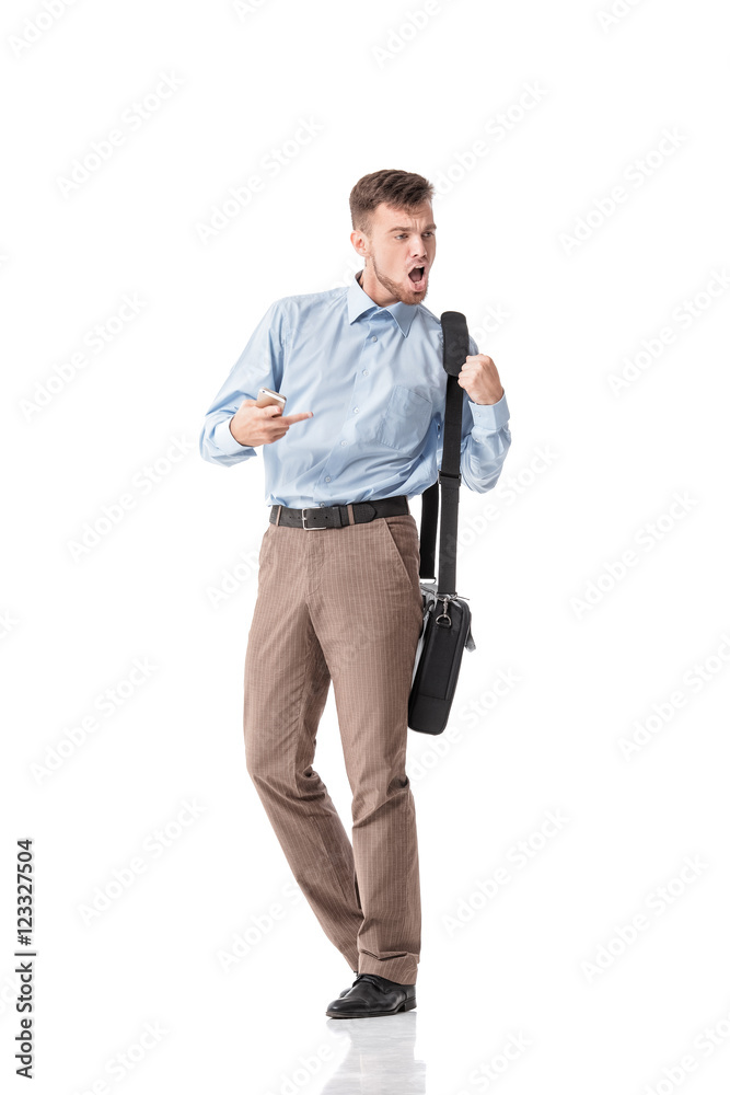 shocked young man looking at phone seeing good news shocked young man looking at phone seeing good news