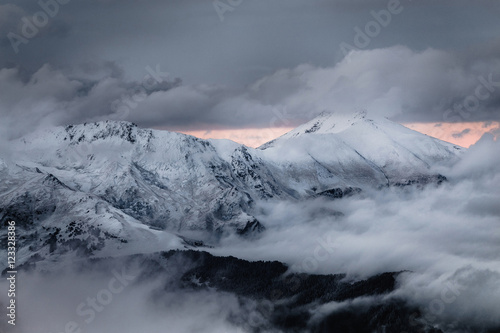 telephoto of mountains with fog and snow