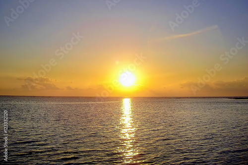 The sun go down behind the horizon of the ocean in the Maldives