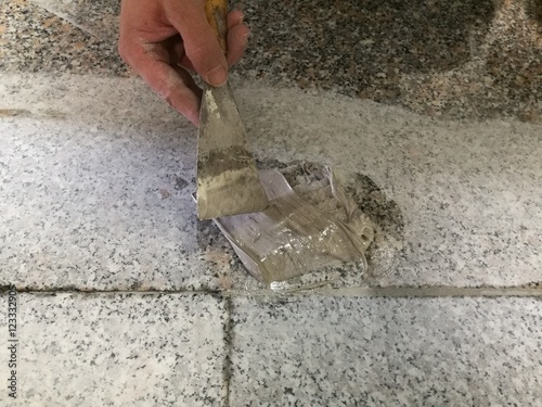 Mason repairing the marble floor