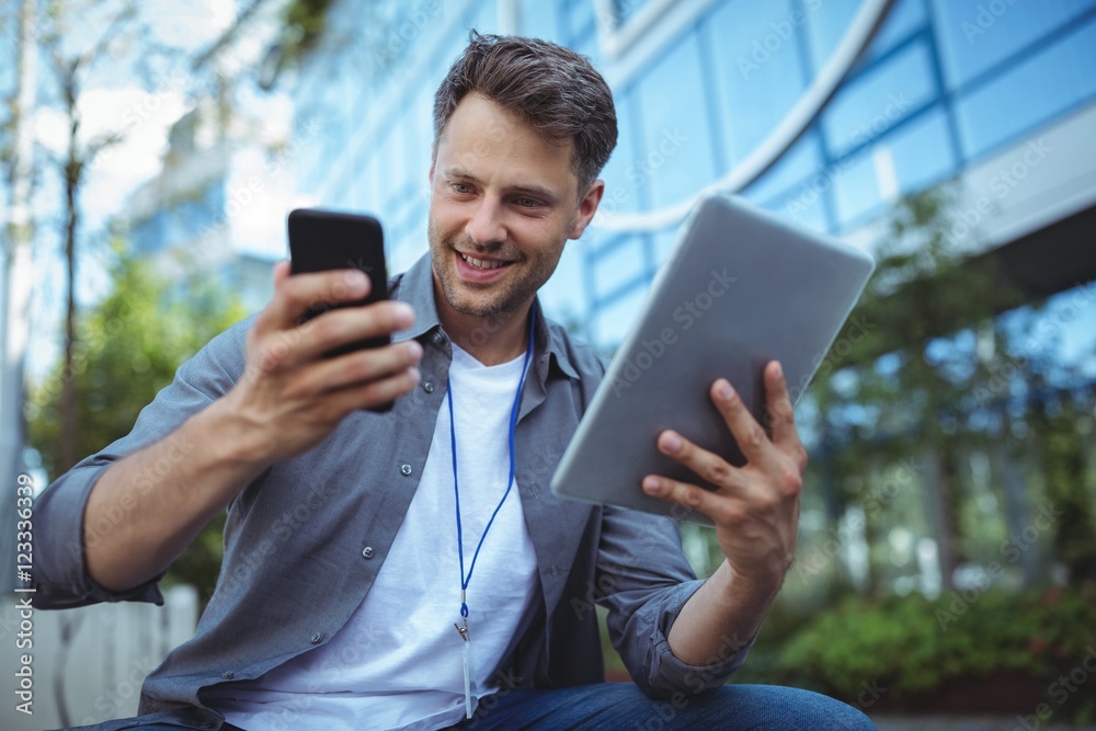 Business executive using mobile phone and digital tablet Business executive using mobile phone and digital tablet