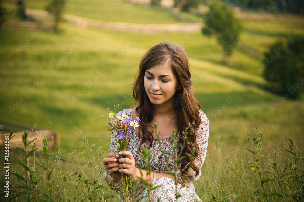 beautiful girl in long dress picking flowers on the meadow beautiful girl in long dress picking flowers on the meadow