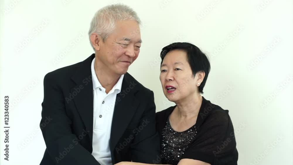 Asian senior couple helping each other to tidy up suit. Long lasting love, relationship goal Asian senior couple helping each other to tidy up suit. Long lasting love, relationship goal