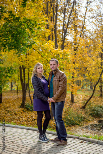 Loving couple in autumn Park. Pregnancy