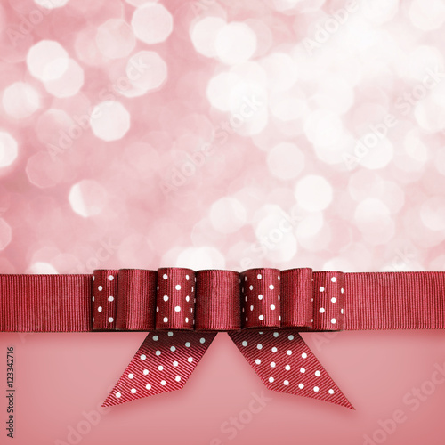 Red ribbon with a bow on re...