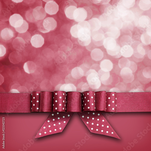Red ribbon with a bow on re...